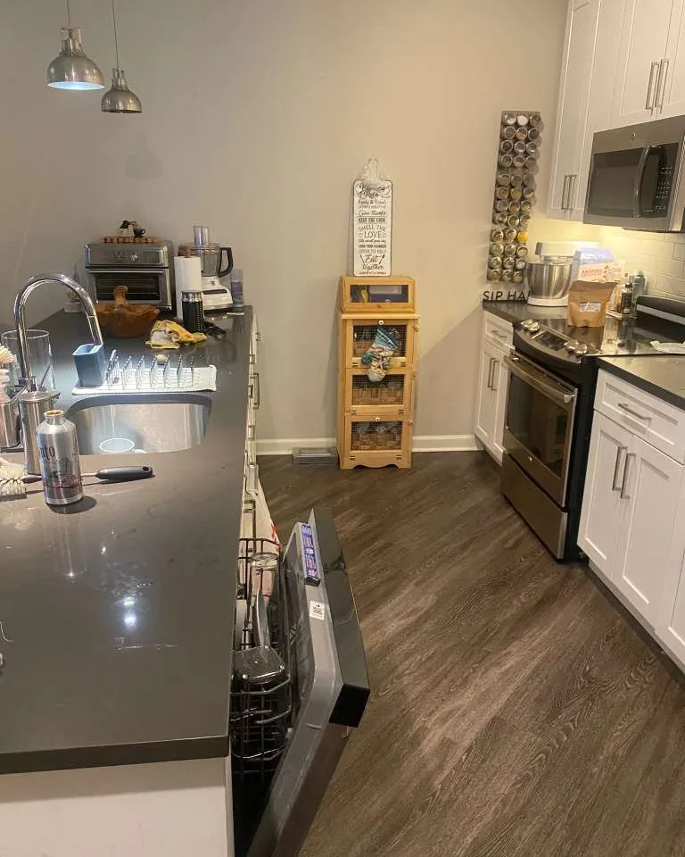 A kitchen counter covered with appliances and dishes.