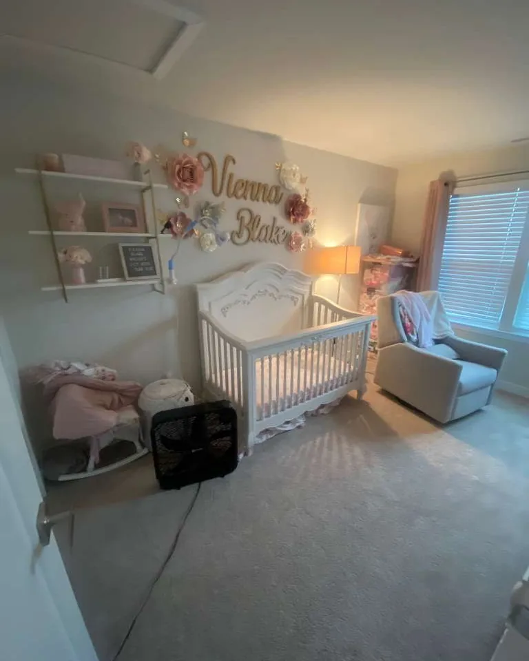 A nursery with toys and equipment across the floor.