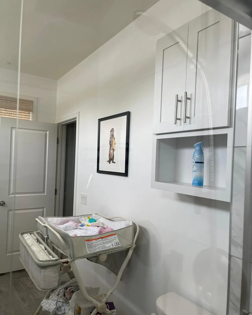 The same shower panel clear enough to read the room behind it.