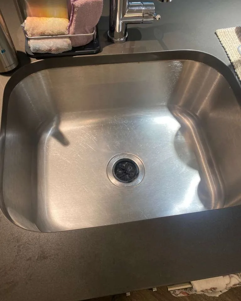 The same sink empty and polished.